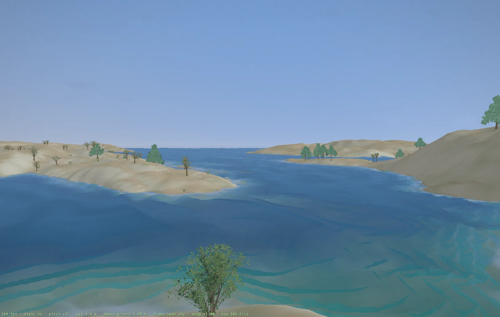 Hīkoi — standing at a shoreline looking across clear water to generated islands
